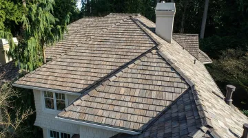 Recycled composite synthetic shingles installed on residential roof surface