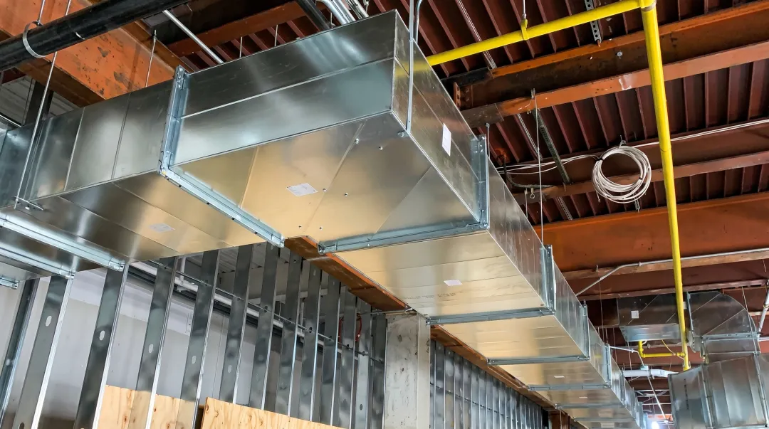 Commercial HVAC ductwork rough-in installation inside commercial building ceiling