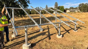 Ground-mount solar racking structure assembly with steel rails and tilt angle set