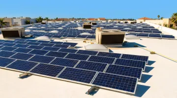 California commercial building with rooftop solar panels and clear blue sky