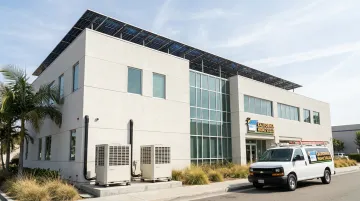 Commercial rooftop solar panels powering heat pump HVAC system on office building