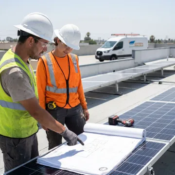 Commercial solar installers reviewing panels