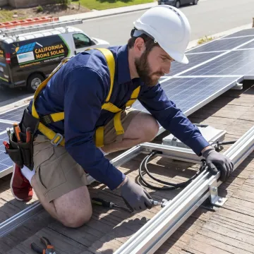 Solar installer reviewing a residential rooftop system