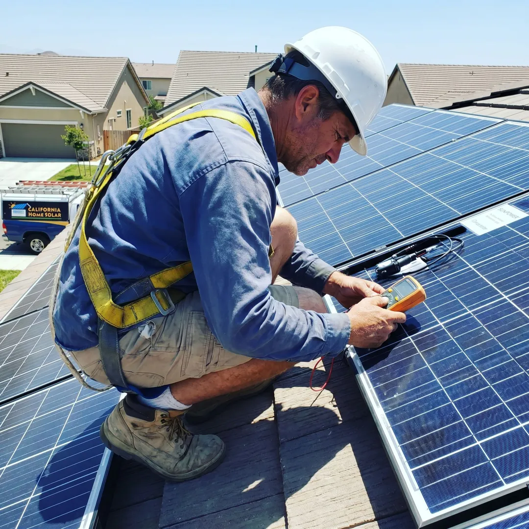 Solar installer reviewing rooftop panels
