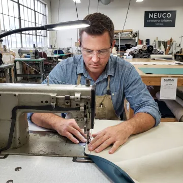 Technician sewing commercial upholstery fabric