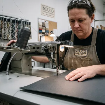 Technician sewing a durable custom textile panel