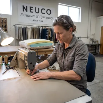 Craftsperson sewing a custom commercial cushion