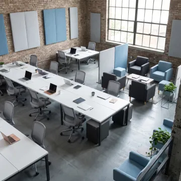 Modern commercial office furnished with coordinated workstations and seating