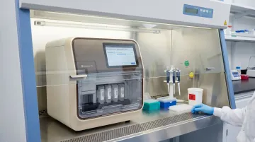 Automated RNA extraction system with closed cartridge design inside biosafety hood