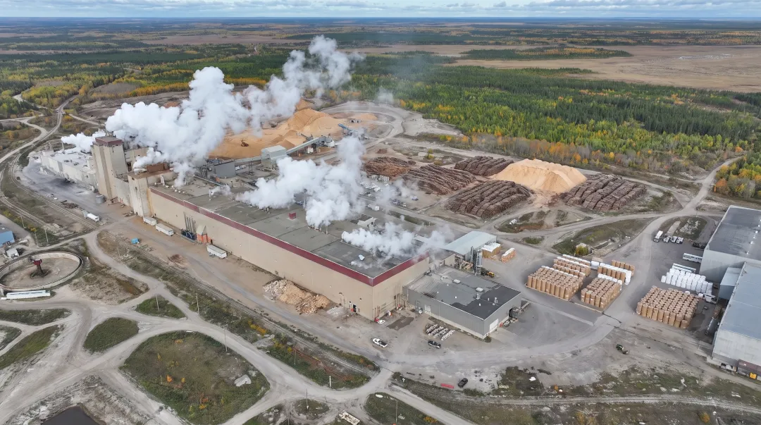 Large containerboard paper mill facility exterior with industrial production infrastructure