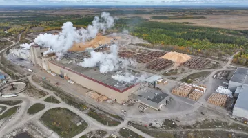 Large containerboard paper mill facility exterior with industrial production infrastructure