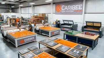 Caribee Sign manufacturing facility CNC routing and Braille sign production floor