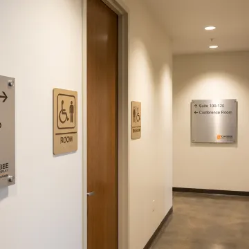 Executive ADA signage in a modern San Antonio office