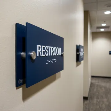 Tactile ADA signs in an office corridor