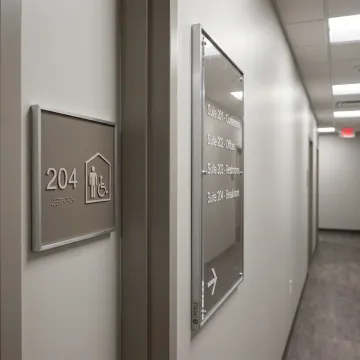 Custom ADA signage installed in commercial hallway