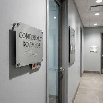 ADA and wayfinding signs in a commercial hallway