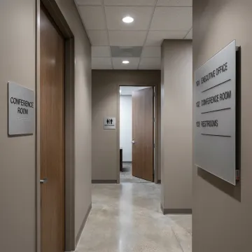 Custom ADA and wayfinding signs in a commercial hallway