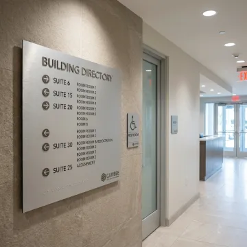 ADA and wayfinding signs in a modern commercial building