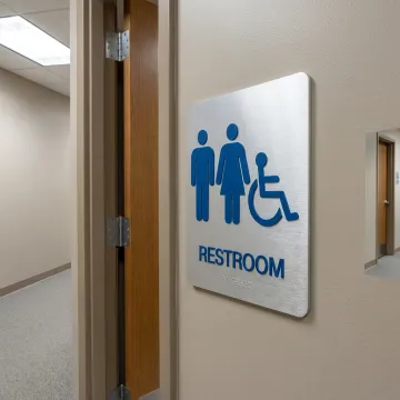 Custom ADA signs in commercial hallway