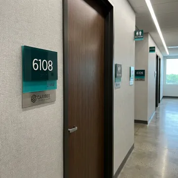 ADA and wayfinding signs in a commercial hallway