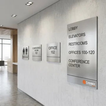ADA and wayfinding signs in a commercial lobby
