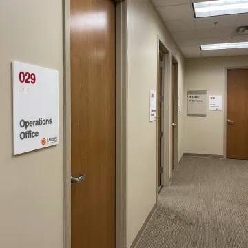 ADA signs and wayfinding signage on a commercial wall