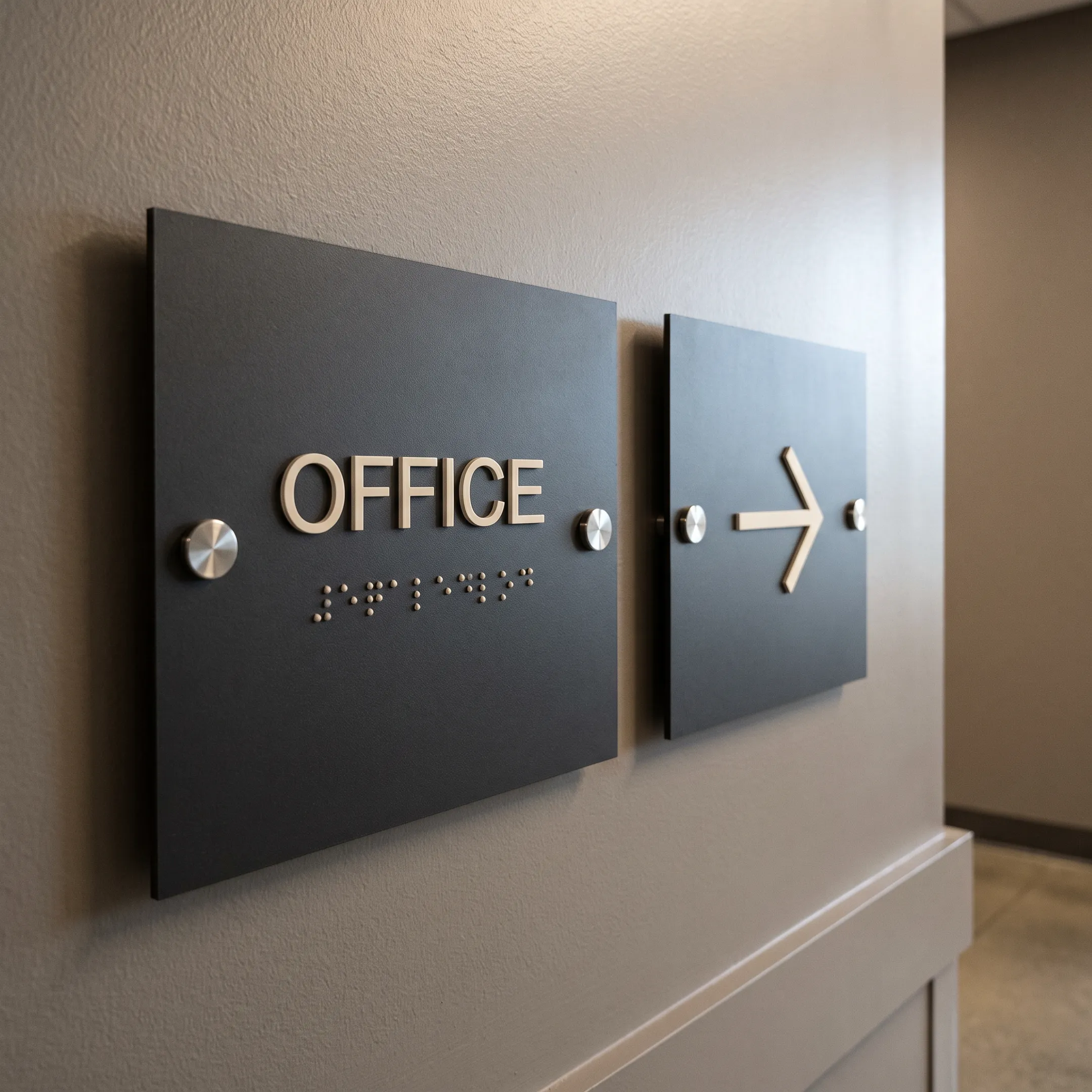 Tactile ADA room sign beside a directional wayfinding panel