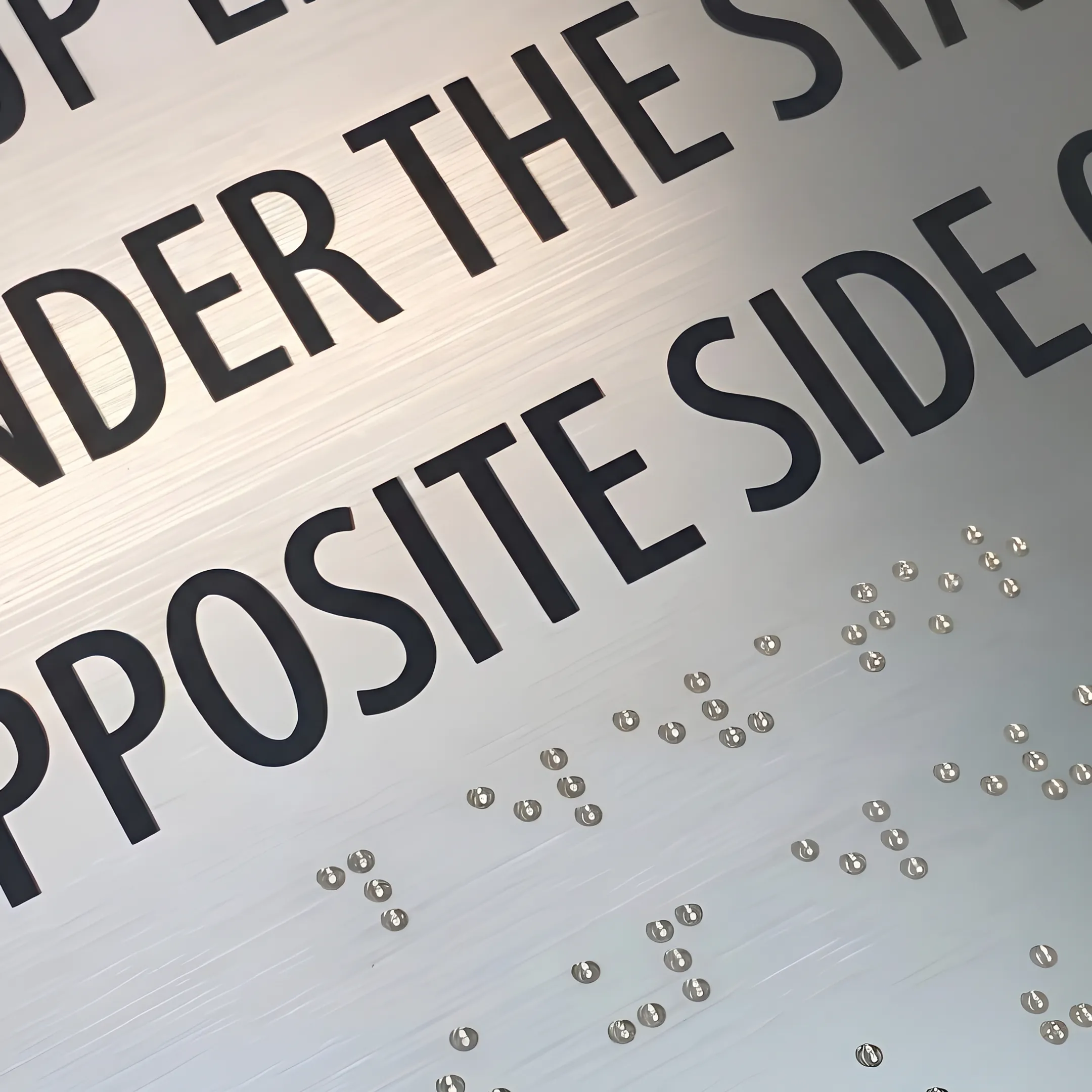 Close-up of a custom tactile ADA office room sign