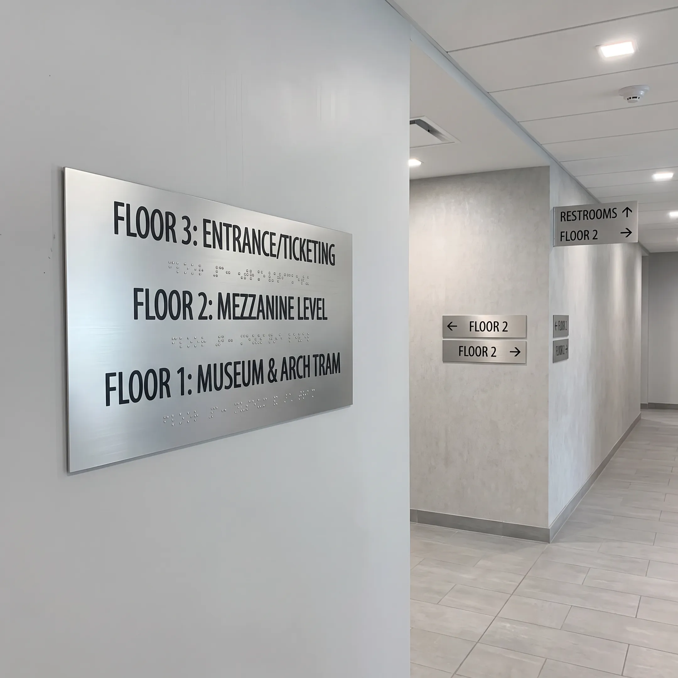 Aluminum ADA directional signs in an office