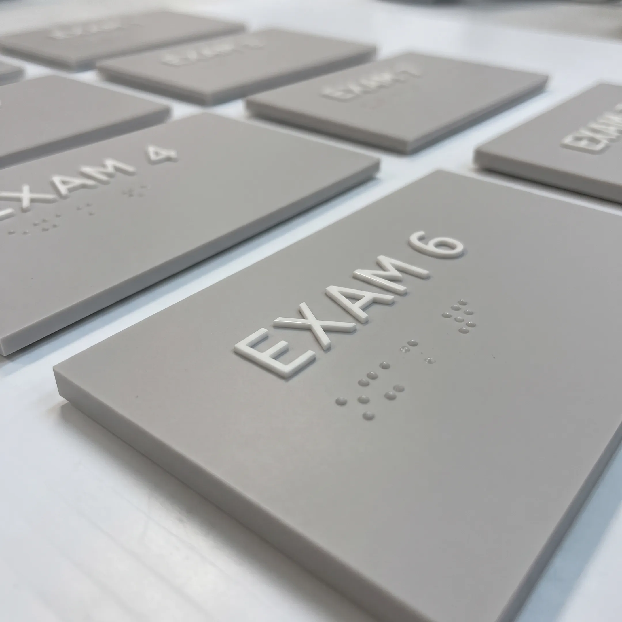 Close-up view of precision wholesale tactile lettering and Braille signage components.