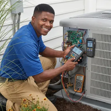 Technician performing detailed diagnostic testing on heat pump system components