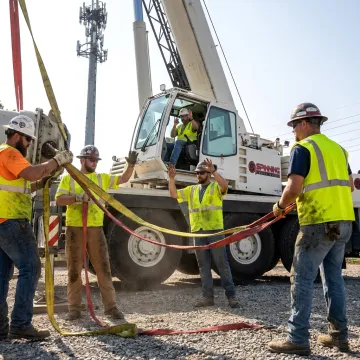 Rigging crew guiding a crane lift