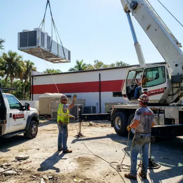 Commercial crane rigging crew lifting heavy equipment in Florida