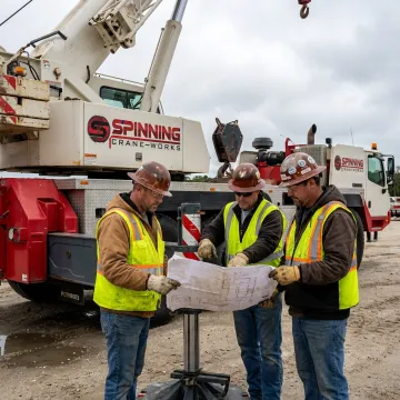 Crane crew planning a heavy lift