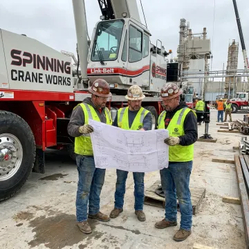 Crane operator and rigging crew planning a lift