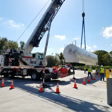 Industrial crane lifting heavy equipment in Florida