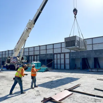 Commercial crane operator lifting equipment in Florida