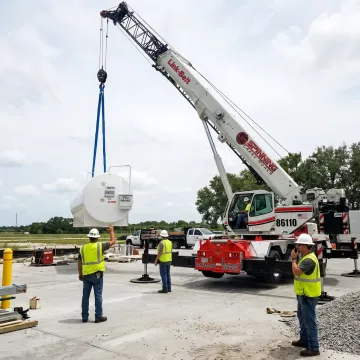 Crane operator coordinating a heavy lift