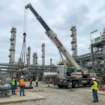 Industrial crane operator managing a heavy lift