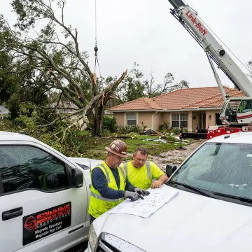 Crane operator planning tree removal lift