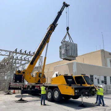 Crane lifting heavy equipment in Florida
