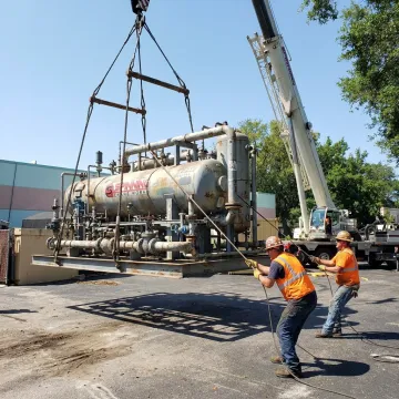 Crane lifting oversized machinery in Florida