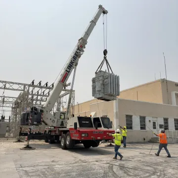 Industrial crane lifting heavy machinery in Florida