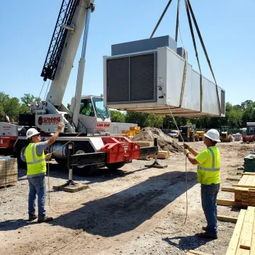 Crane rigging crew lifting heavy equipment in Orlando