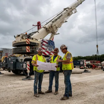 Crane crew planning a commercial construction lift