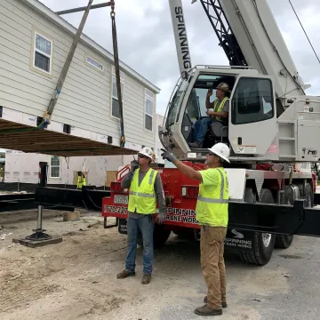 Crane operator coordinating a safe lift
