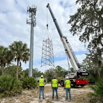 Crane lifting cell tower sections in Florida