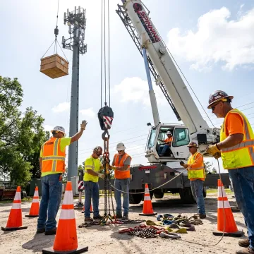 Crane operator coordinating a safe lift
