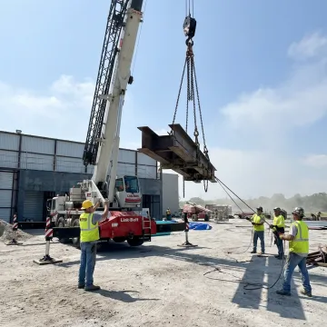 Industrial crane rigging crew lifting heavy equipment in Florida