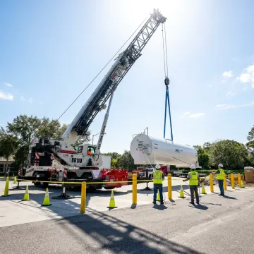 Crane operator lifting heavy equipment in Florida